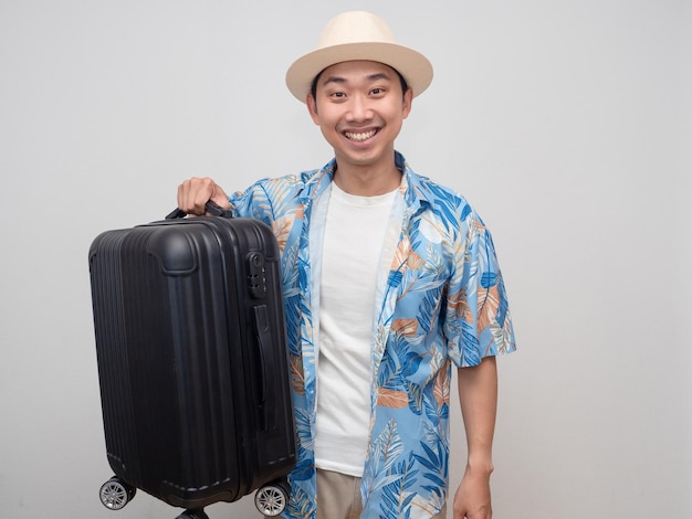 Positive traveler man smile happy and hold luggage isolated