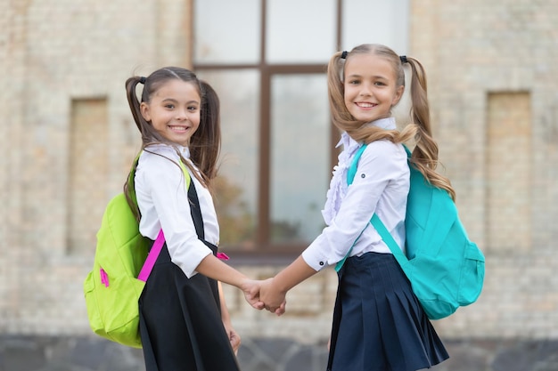 Positive two school girls best friends together outdoor