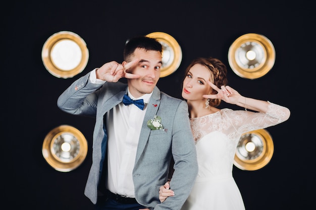 Positive wedding couple having fun and dancing at party