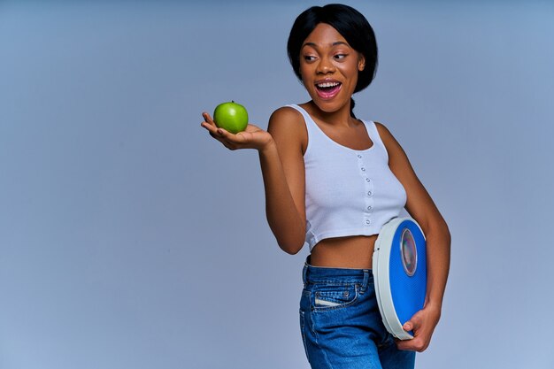 https://img.freepik.com/premium-photo/positive-woman-holds-purple-scales-her-hand-green-apple-outstretched-palm-diet-concept_283411-324.jpg