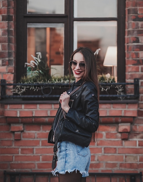 Positive woman  in leather jacket