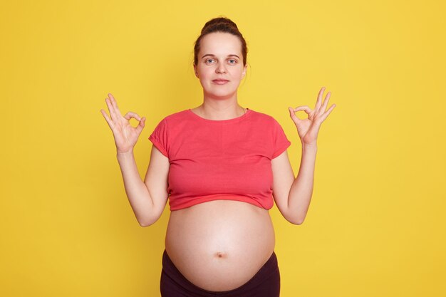 Positive woman showing ok sign with both hands