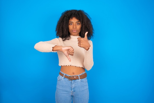 Photo positive woman showing thumb up down sign