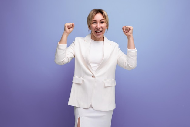 Positive young blond office woman in white jacket and skirt