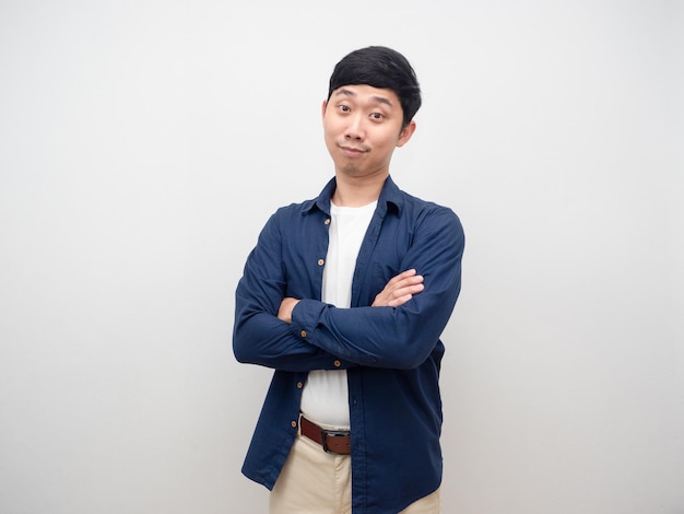 Positive young man standing cross arm smile studio shot isolated