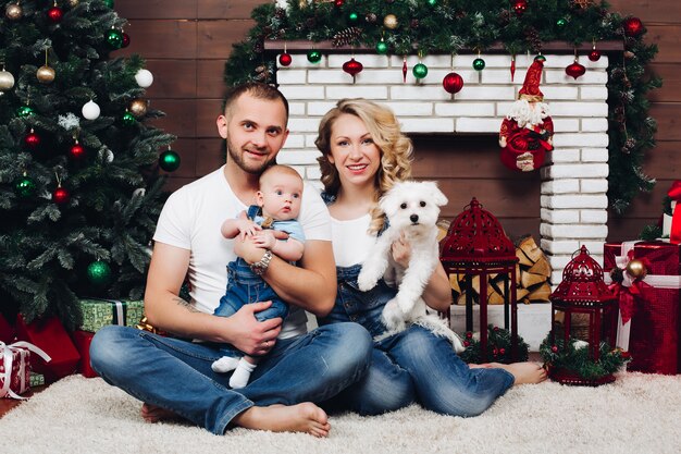 Positivity family posing together near fireplace and presents for Christmas