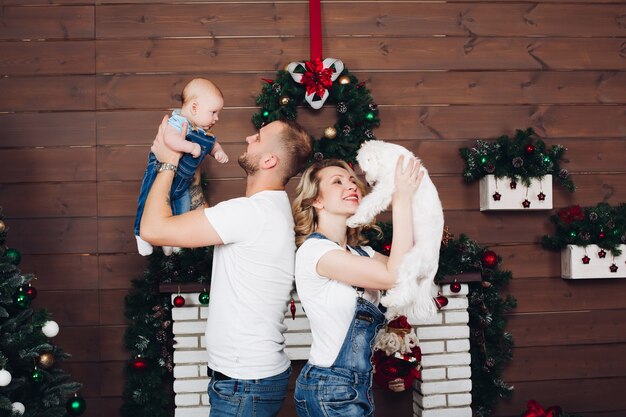 Positivity family posing together near fireplace and presents for Christmas