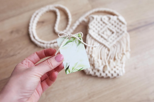 Post card for your text handmade macrame bag in blur background\
hobby knitting handmade macrame modern summer concept