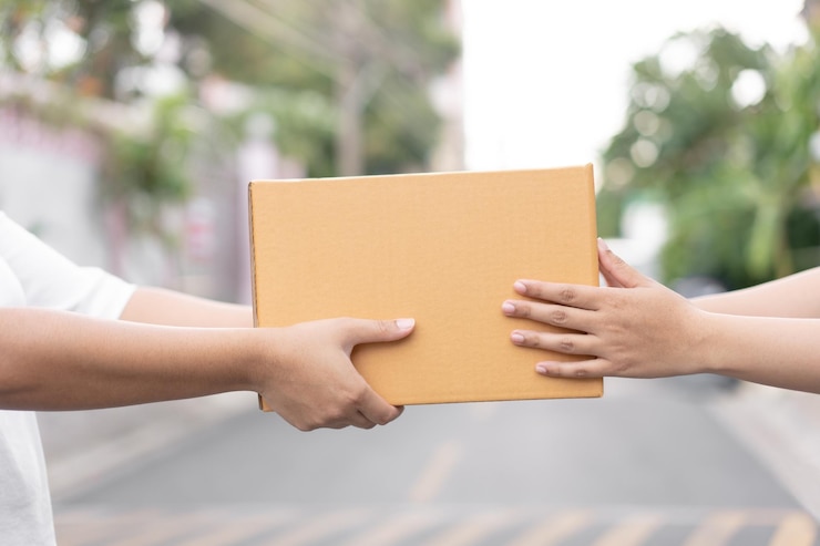Photo postal delivery courier delivering package to customer outdoor