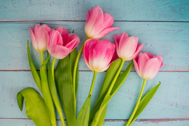 Postcard beautiful flowers tulips on a swooden  background for Mothers Day holiday March 8