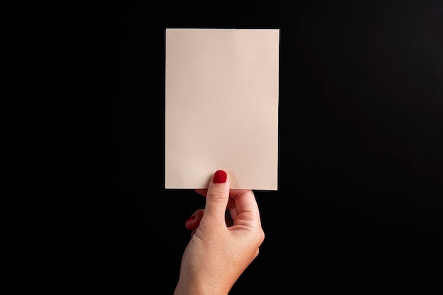 Postcard held by a female hand on a black background For ecommerce or small business