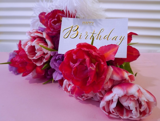 Photo postcard internet banner with a birthday greeting with the inscription happy birthday a bouquet