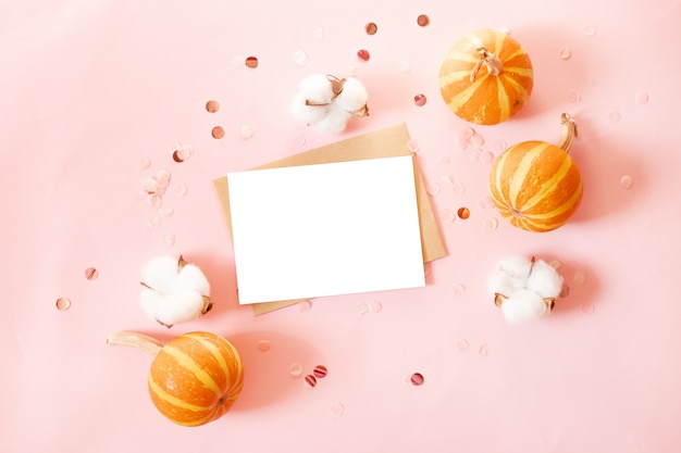 Postcard with craft paper envelope and small pumpkins, glitter decor and cotton flowers