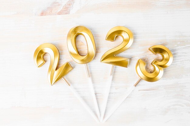 Postcard with numbers 2023 on a white wooden background flat lay christmas and new year