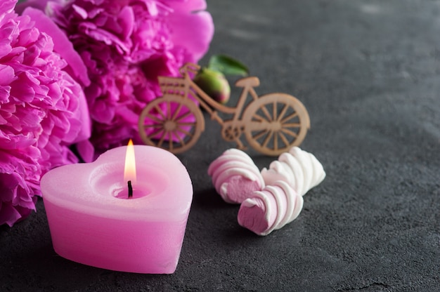 Postcard with peony flowers and candle