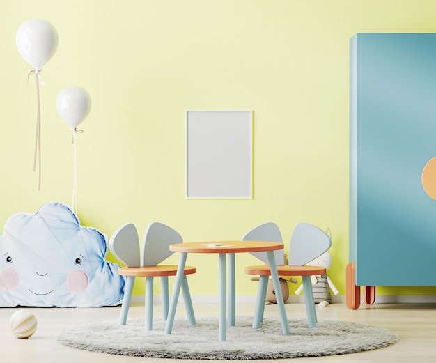 Poster frame in bright yellow child room with table, toys and cupboard