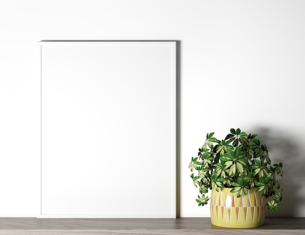 Photo poster frame on white wall with plant