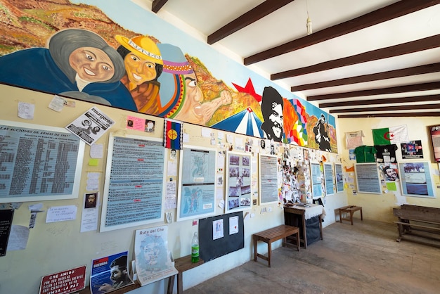 Photo posters and paintings on wall of historic school at la higuera