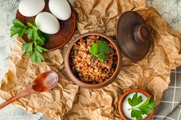 A pot of buckwheat porridge and boiled eggs balanced nutrition anticrisis food diet healthy lunch or...