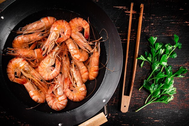 Pot of cooking shrimp with parsley