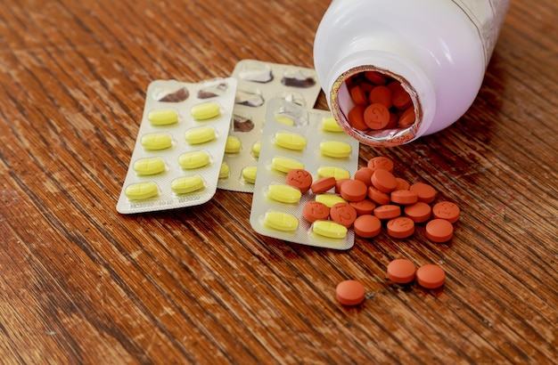 Pot of white tablets and their bottle medicine