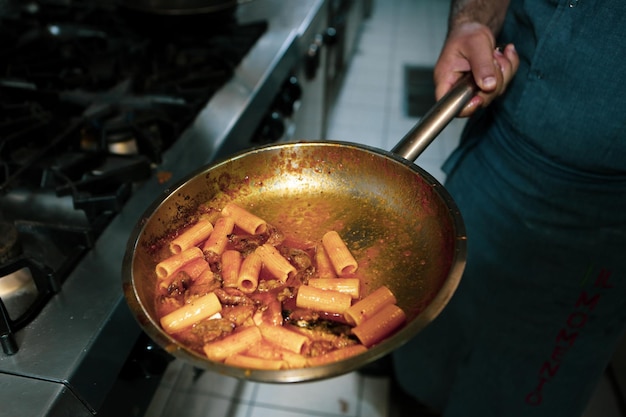 pot with pasta on the fire stove cooking