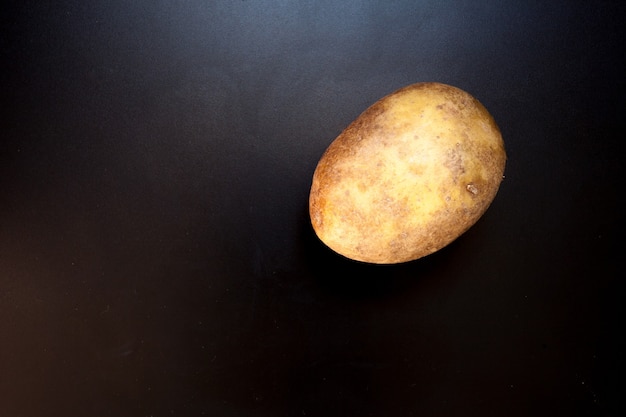 Potato on black table