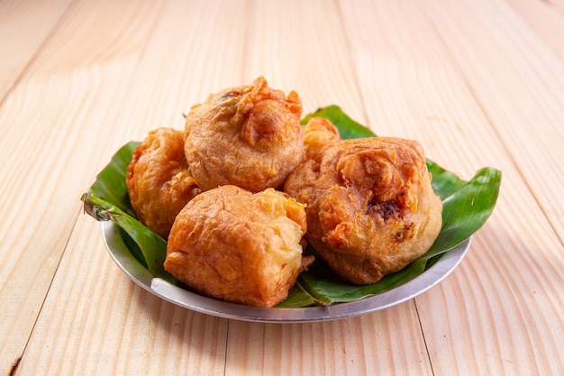 Potato Bonda Indian spicy snack arranged in a steel plate lined with banana leaf