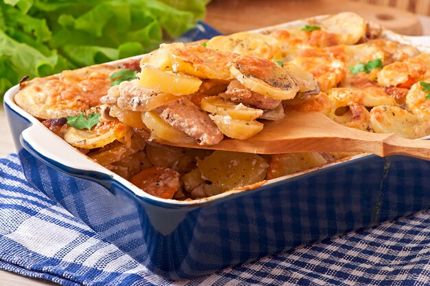 Potato casserole with meat and mushrooms with cheese crust