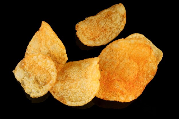 Potato chips on a black surface