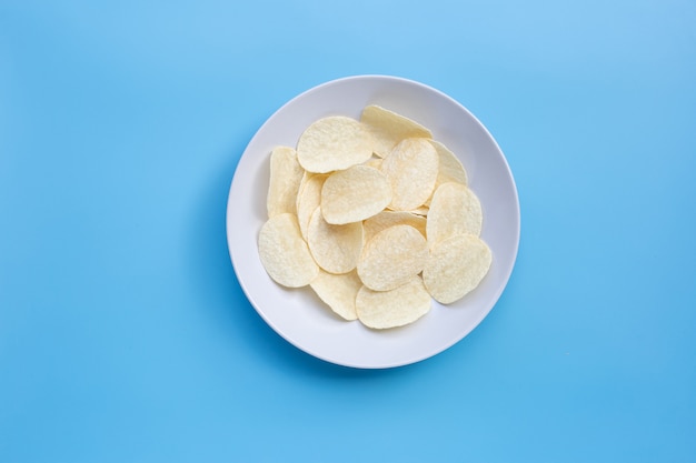 Potato chips on blue background.