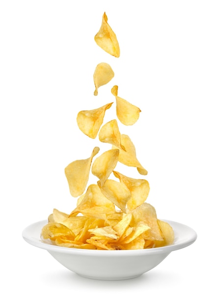 Картофельные чипсы падают в тарелку. Изолированные на белом фоне