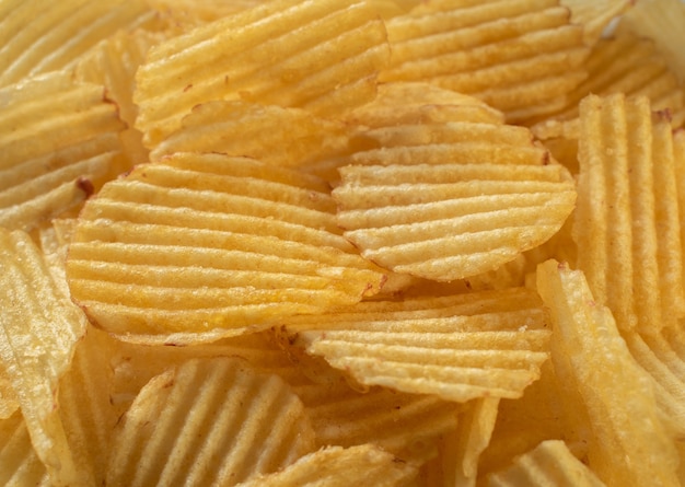 Potato chips scattering close up texture