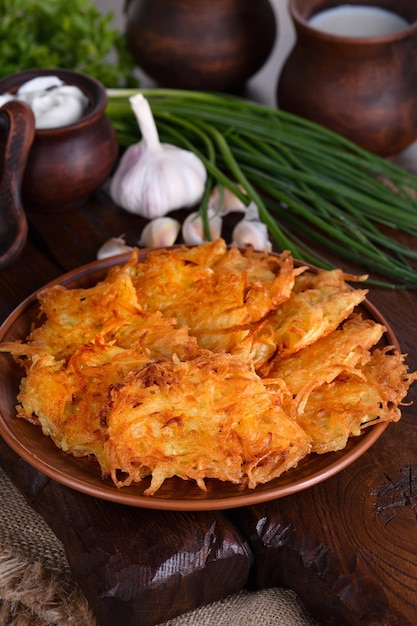 Potato fritters a pancake especially one made with grated potato served with sour cream herbs and a jug of milk Country style