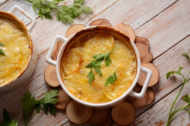 Potato gratin in baking white cocotte