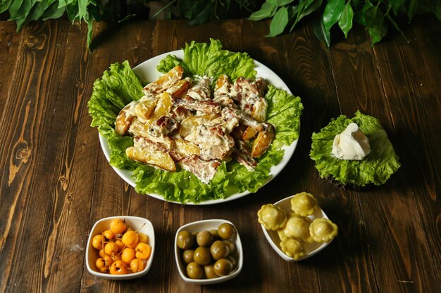 potato and lettuce salad on wooden table
