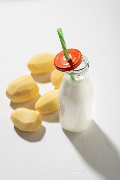 Potato milk concept Bottle with potato milk on a white background An alternative to animal products Vegan food