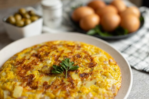 Potato omelette with eggs served on marble table