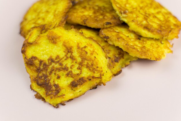 Potato pancakes on a light pink plate