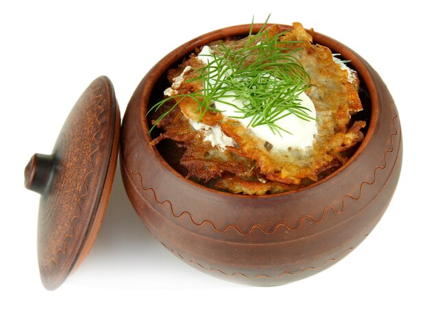 Potato pancakes in pot isolated on white