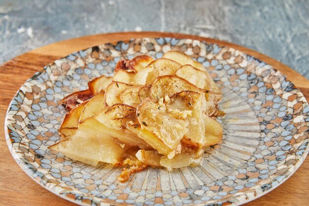 Potato pie with garlic and thyme on plate