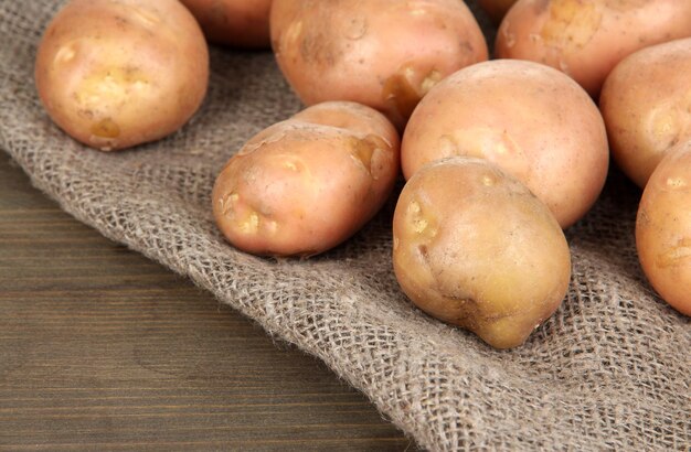 Potato on sackcloth on wooden table