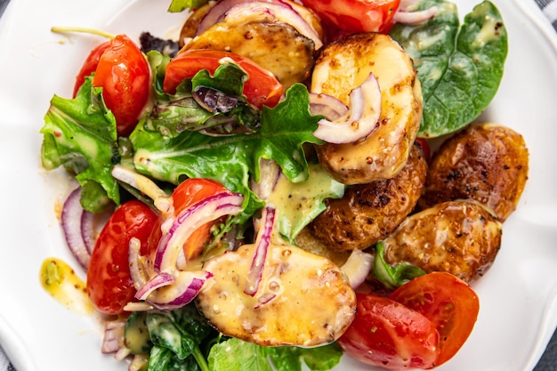 potato salad and vegetable baked potato tomato onion salad leaves salad dressing vinaigrette