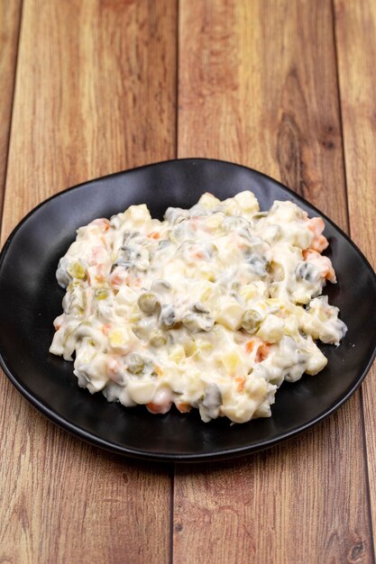 Potato salad with mayonnaise Traditional salad with cooked vegetables with mayonnaise Russian salad