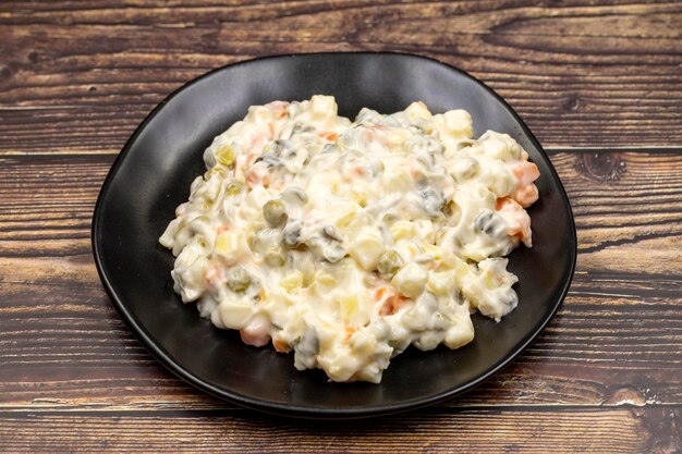 Potato salad with mayonnaise Traditional salad with cooked vegetables with mayonnaise Russian salad