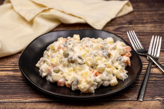 Potato salad with mayonnaise Traditional salad with cooked vegetables with mayonnaise Russian salad