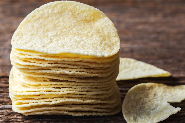 Potato slice chips crisps on wooden planks.Macro photo