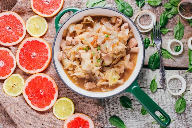 Potato stew with meat on the table, restaurant dish on a wooden background top view