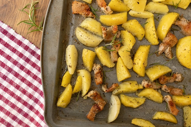 Potato wedges oven roasted with rosmary in a baking tray