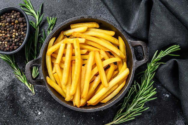 Potatoes fries, French fries with rosemary in the pan